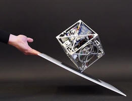 The Cubli: A Gravity Defying Cube that Can Jump, Balance, and Walk