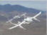 Scaled Composite's contender for the X-Prize race to space contest - the White Knight carries SpaceShipOne (the actual space vehicle) over windmills west of Mojave, with Beech Starship flying chase.