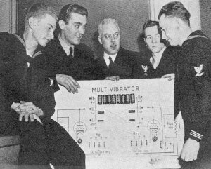 RF Cafe - Radio Amateurs in Navy Radio, A group of Radio Chicago instructors gathered around a giant working model of a multivibrator, April 1045 QST