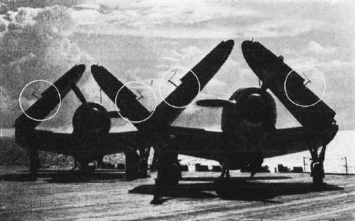 radar antennas are silhouetted atop folded wings of these Curtiss Helldivers - RF Cafe