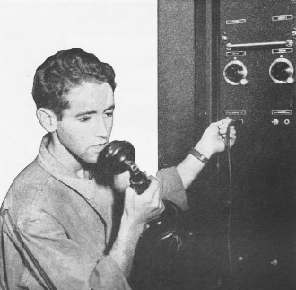 Radio specialist checks ground station transmitter - RF Cafe